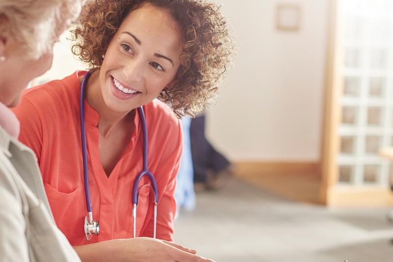 Woman doctor consulting elderly woman patient