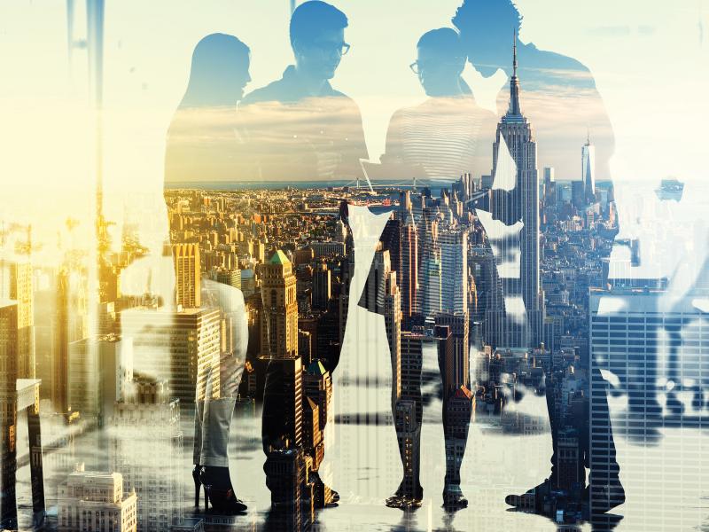 4 people have a group meeting in an outdoor environment