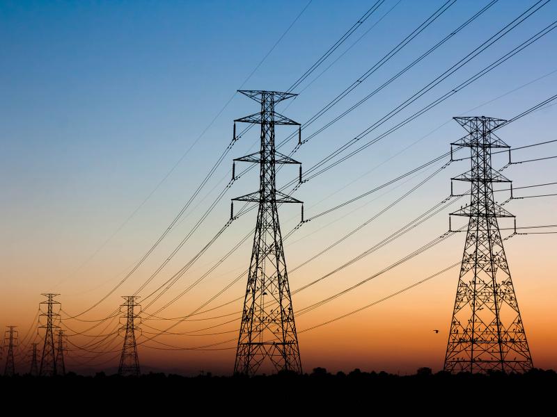 Electrical towers with cables in a sunset haze