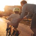 Father and son in the sunset biking.