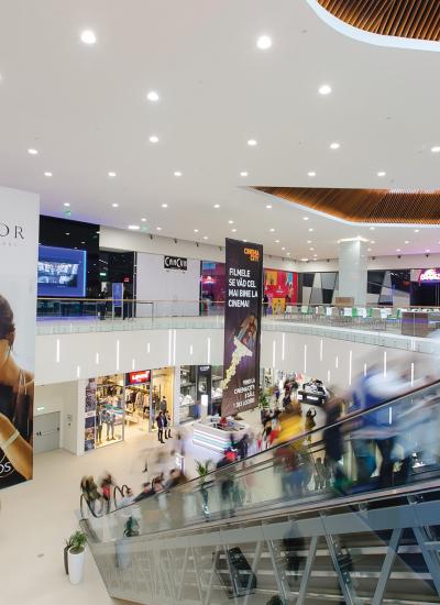 Escalator and entrances to shops in city mall