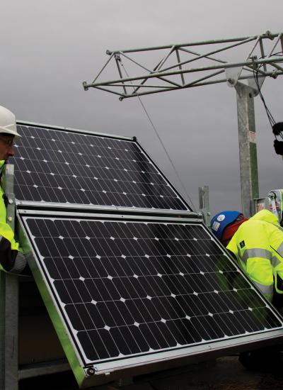 Men installing solar panel