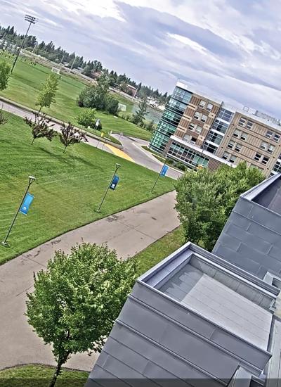 Exterior of campus viewed above from tilted angle, green grass outside.